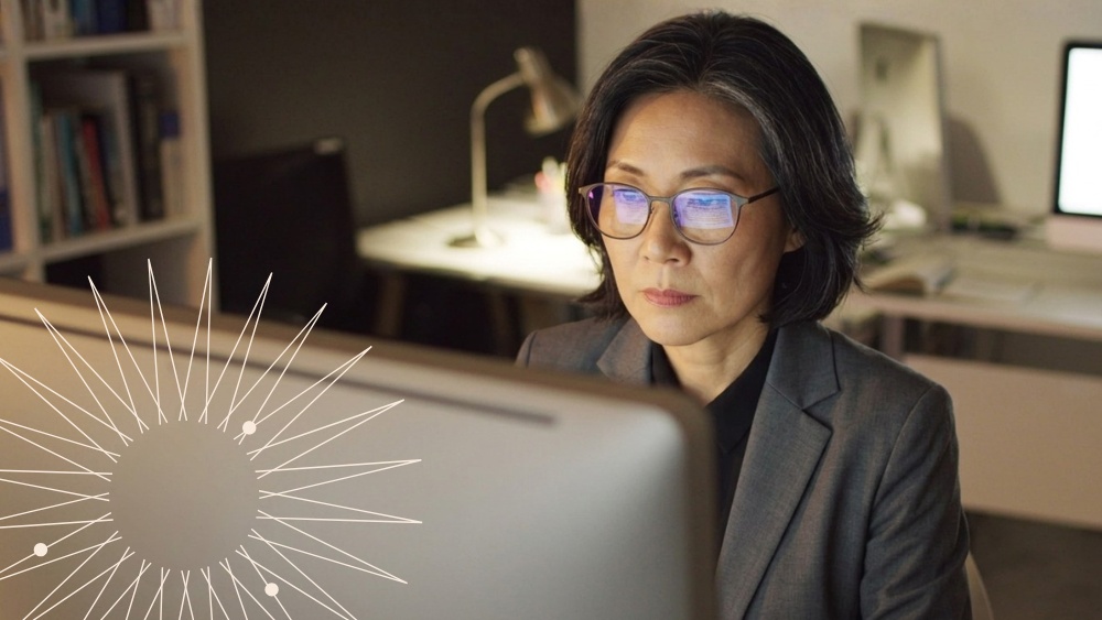 Professional working at a desktop computer in an office setting, representing AI‑powered legal research.