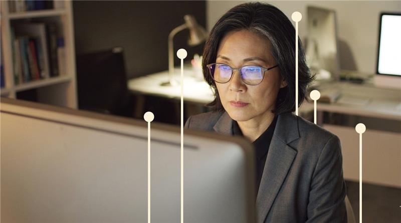 Professional working at a desktop computer in an office setting, representing AI‑powered legal research.